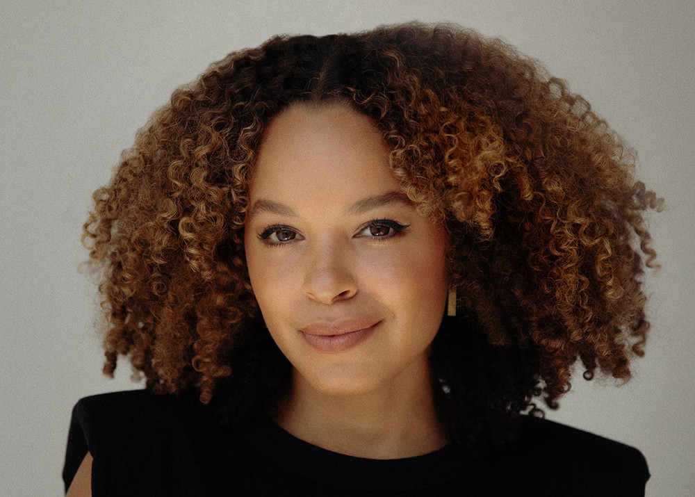 Headshot of a woman wearing a black shirt smiling